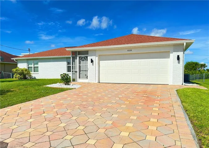 Single family home with a garage and a front lawn