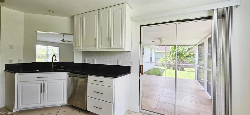 Kitchen featuring white cabinets, sink, and stainless steel appliances