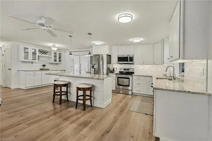 Renovated kitchen with new cabinetry, granite counters, appliances