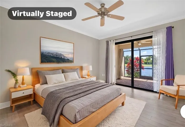 Spacious bedroom with  glass doors opening to a screened lanai and water views.