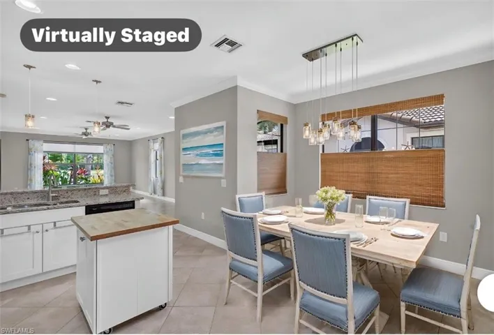 Dining area featuring a modern linear chandelier, tile flooring, and multiple windows with woven blinds that bring in a lot of natural light.