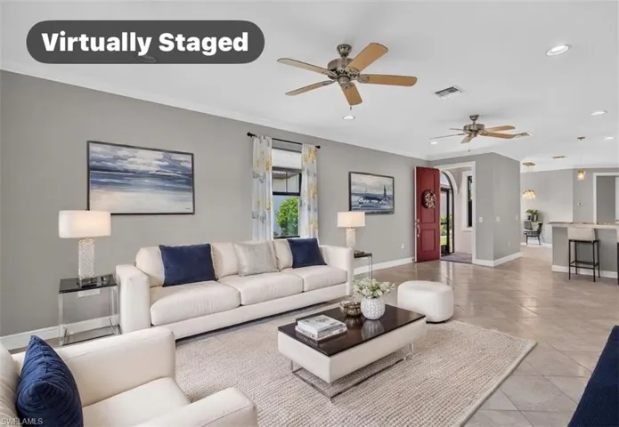 Spacious living area featuring light gray walls, ceiling fans, recessed lighting, and tile flooring