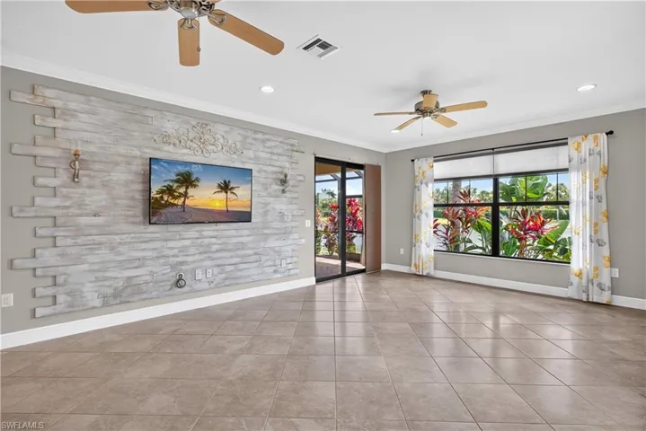 Living room with custom accent wall and a TV that stays with the home.