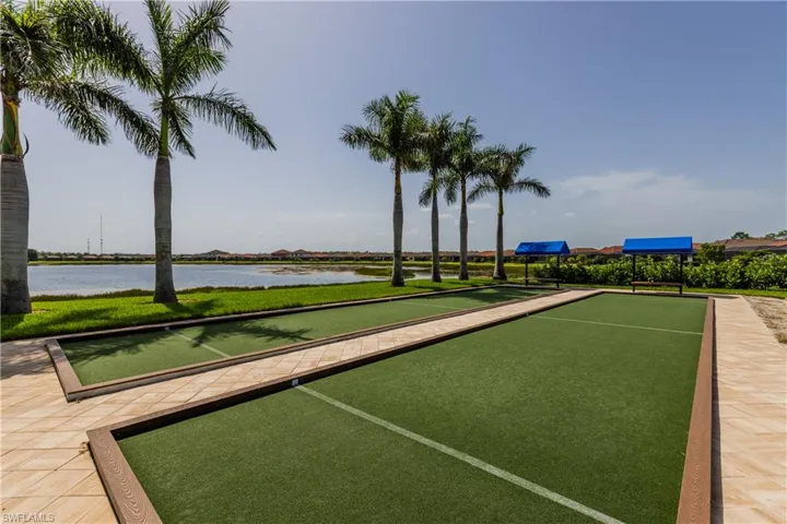 Dual bocce ball courts featuring artificial turf surfaces and stone-finish surrounds