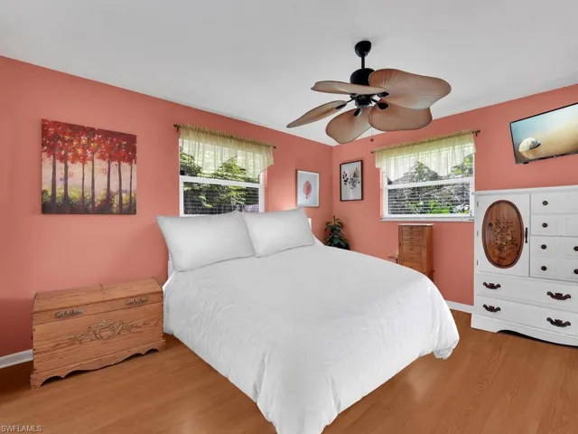 Bedroom with hardwood / wood-style floors and ceiling fan