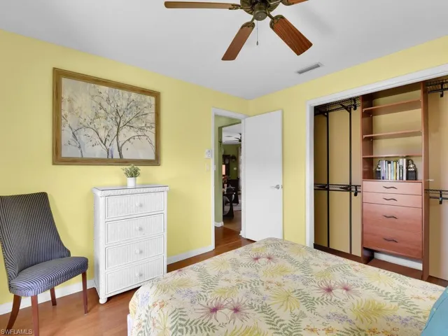 Bedroom with a closet, ceiling fan, and hardwood / wood-style floors