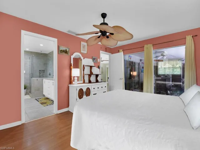 Bedroom with ceiling fan, light hardwood / wood-style flooring, and ensuite bathroom