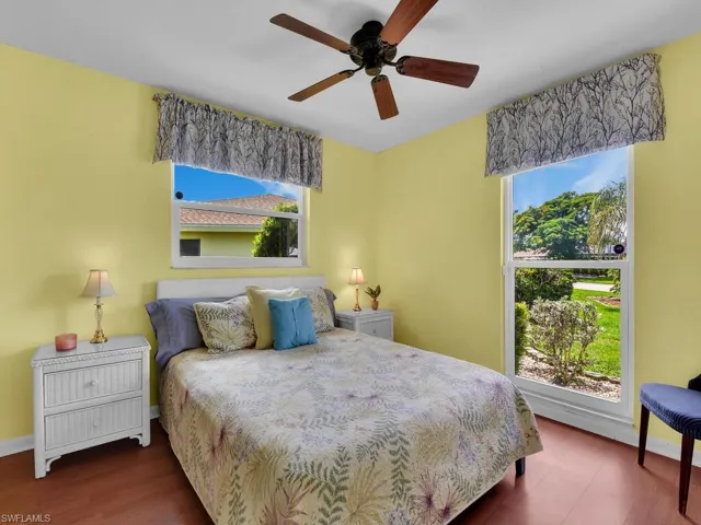 Bedroom featuring ceiling fan and dark hardwood / wood-style floors