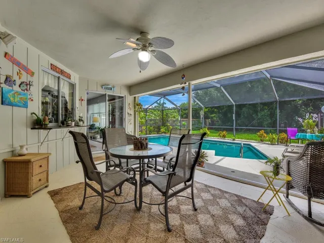 View of pool with ceiling fan, a patio area, and a lanai