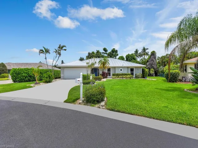 Ranch-style home with a garage and a front yard
