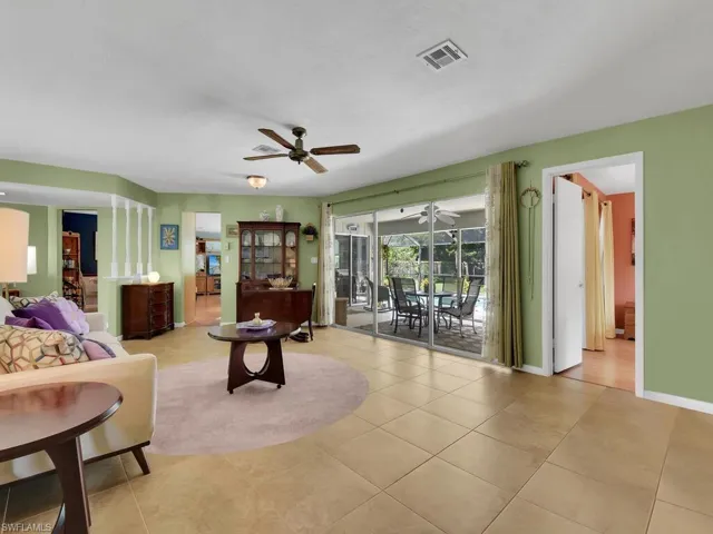 Tiled living room featuring ceiling fan