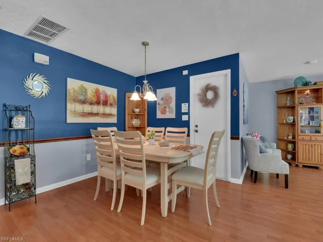 Dining area featuring hardwood / wood-style floors and a chandelier