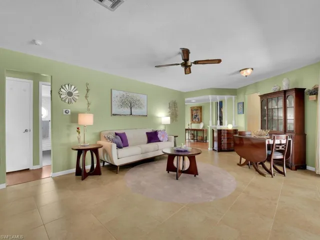 Living room featuring ceiling fan and light tile patterned flooring