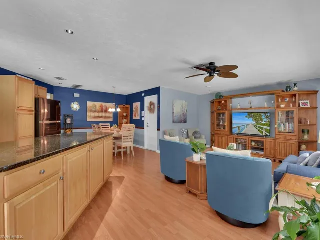 Living room featuring ceiling fan and light hardwood / wood-style floors