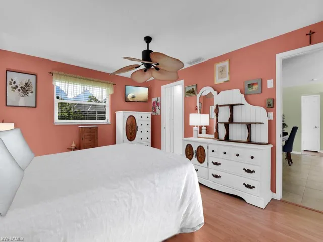 Bedroom featuring ceiling fan and light hardwood / wood-style flooring