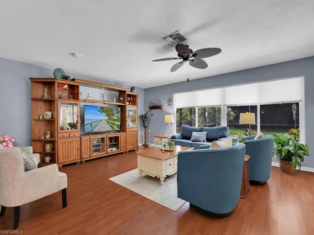 Living room featuring ceiling fan and wood-type flooring