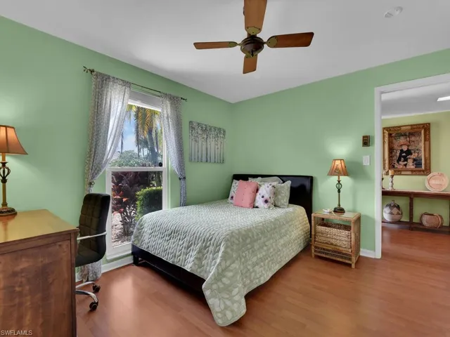 Bedroom with hardwood / wood-style flooring and ceiling fan