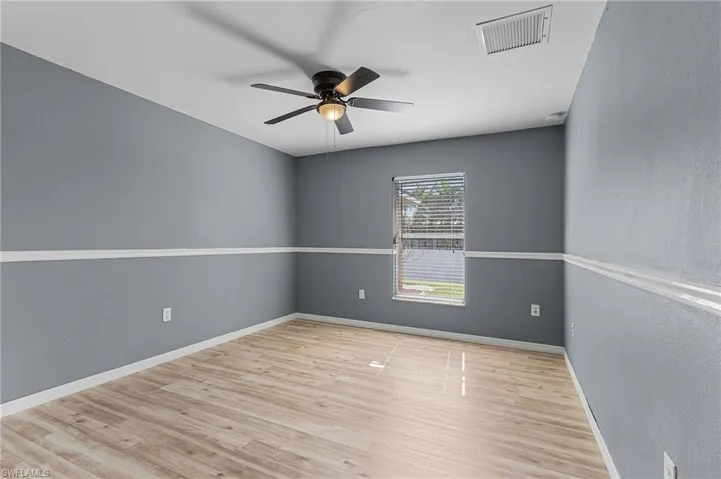 Spare room with ceiling fan and vinyl wood-style flooring