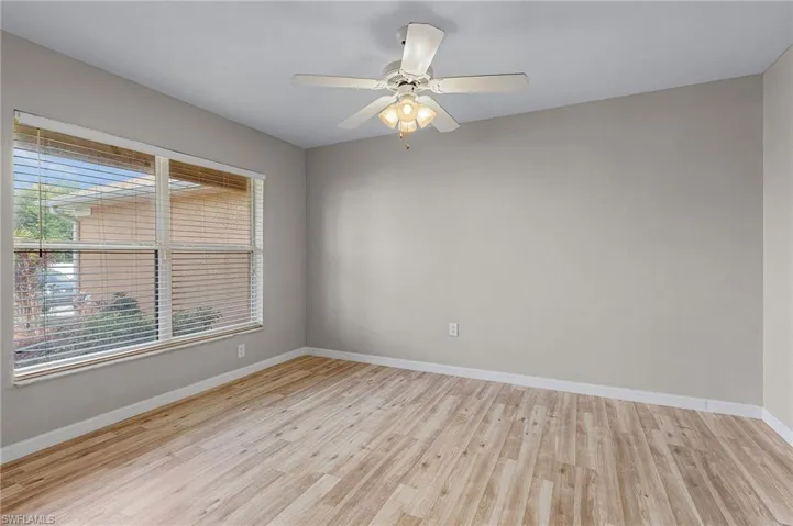 Den/office with vinyl flooring and ceiling fan/light