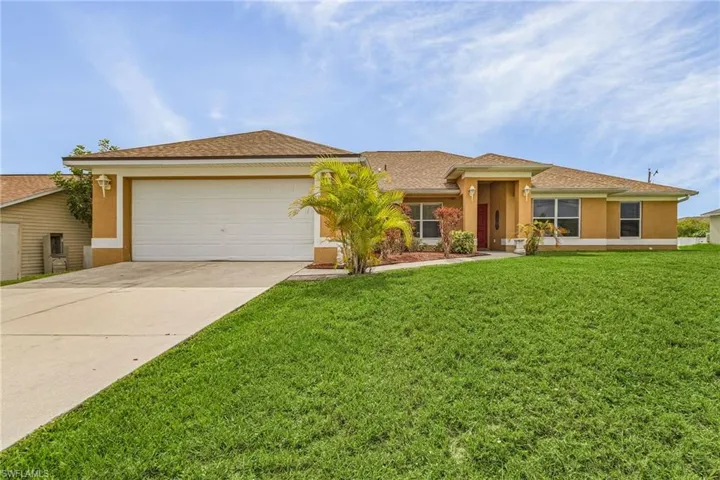 Single story home with a front lawn and 2 car garage