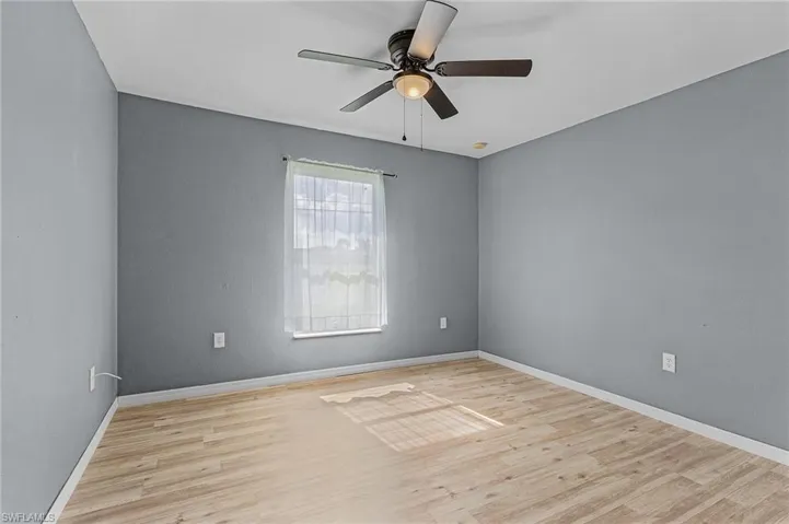 Unfurnished room with vinyl wood-type flooring and ceiling fan