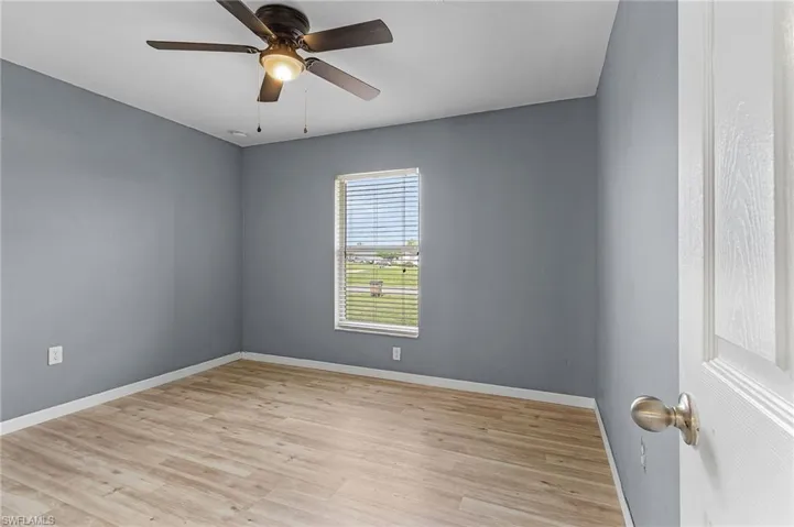 Spare room with vinyl flooring and ceiling fan/light