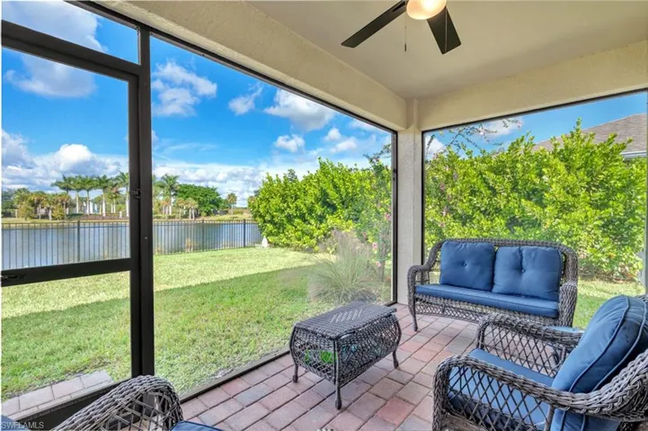 Sunroom / solarium with outdoor lounge area, a ceiling fan, and a patio
