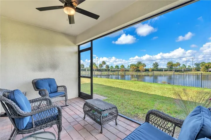 Sunroom featuring a water view, an outdoor living space, and a ceiling fan