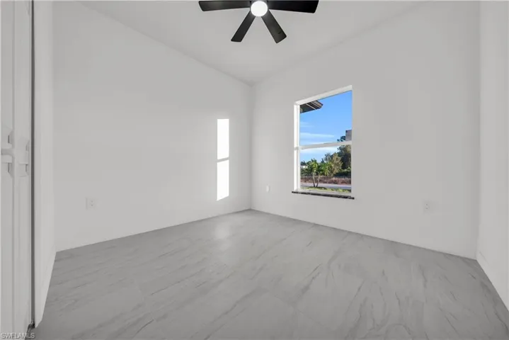 Spare room with vaulted ceiling and ceiling fan