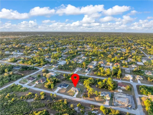 Aerial view of property's location featuring nearby suburban area