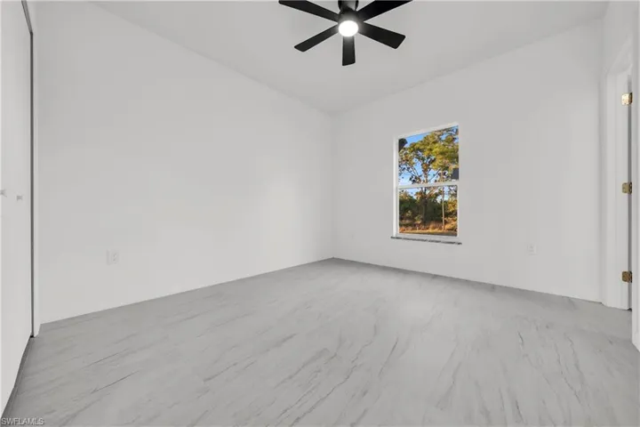 Spare room with ceiling fan