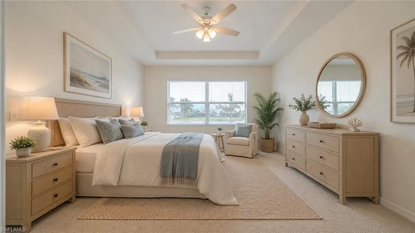 Virtual Spacious bedroom featuring a tray ceiling, ceiling fan with integrated lighting, expansive window, and neutral carpeting