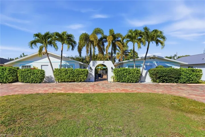 View of front of property with a front lawn and stucco siding
