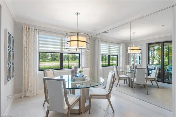 Dining room featuring a healthy amount of sunlight, light tile flooring, and crown molding