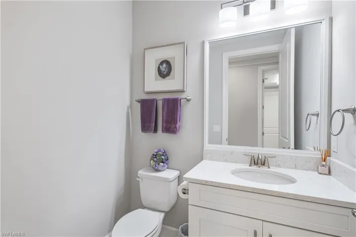 Bathroom featuring toilet and large vanity