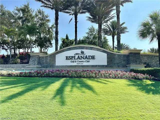 Community / neighborhood sign with a yard