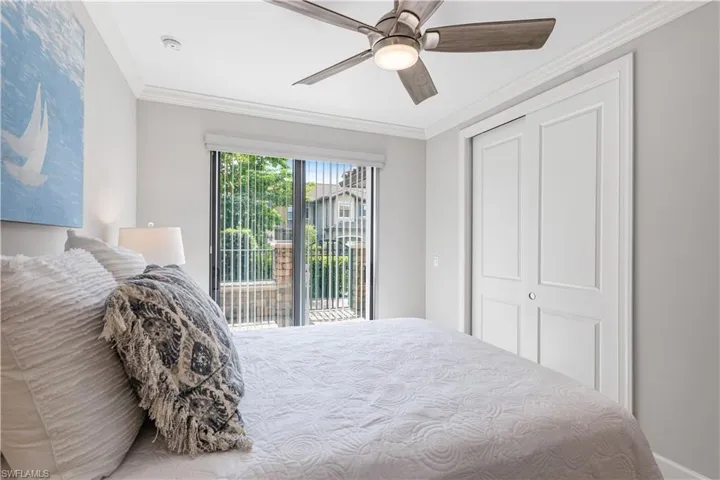 Bedroom with ceiling fan, access to exterior, a closet, and crown molding