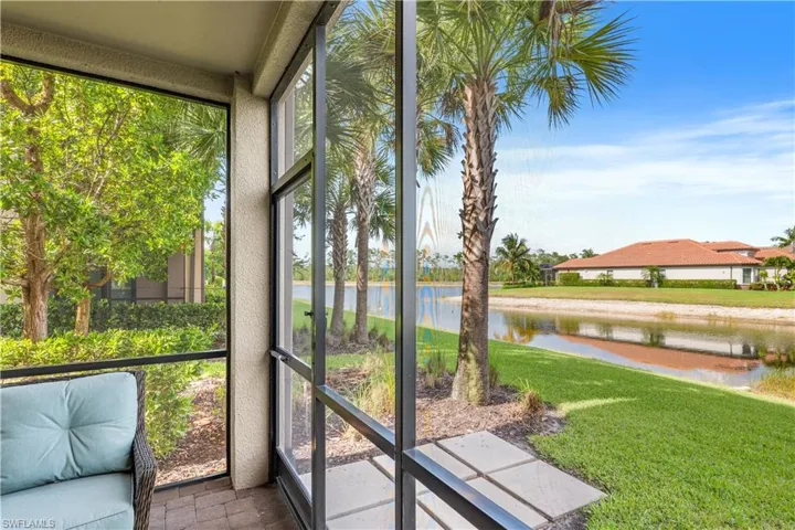 Sunroom featuring a water view