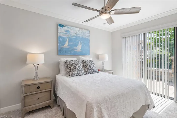 Carpeted bedroom featuring access to outside, crown molding, and ceiling fan