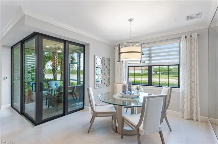 Tiled dining area featuring crown molding