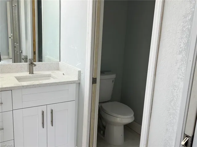 Bathroom with toilet and large vanity
