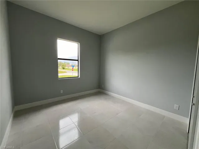 Unfurnished room featuring light tile patterned floors