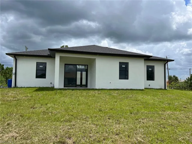 Rear view of property featuring a lawn