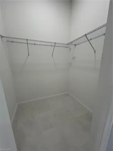 Walk in closet featuring tile patterned flooring