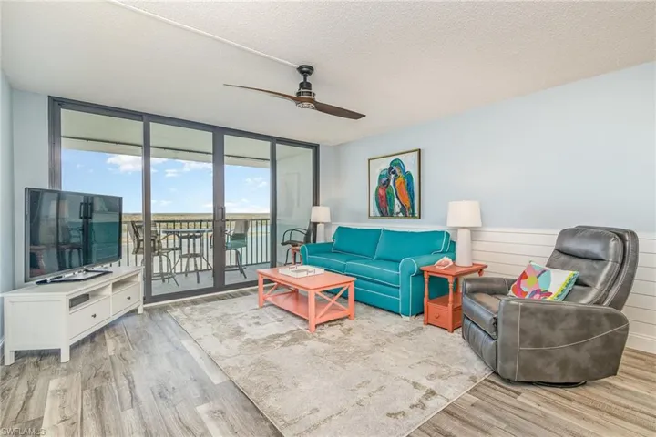 LIVING AREA.  SHIPLAP ACCENT ON WALLS.  WOOD-LOOK PLANK TILE FLOORING.  IMPACT RESISTANT SLIDING DOORS.  UPSCALE FURNISHINGS.