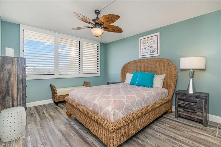 SOUTHERN EXPOSURE GUEST BEDROOM W/UPDATED FAN.  PLANTATION SHUTTERS.  WALK-IN CLOSET IS TO LEFT.
