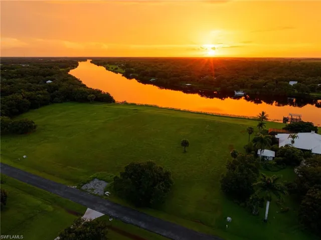 Aerial view at dusk featuring a water view
