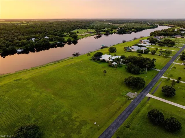 Aerial view at dusk featuring a water view