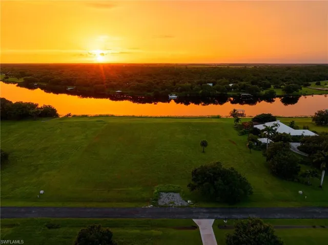 Aerial view at dusk featuring a water view