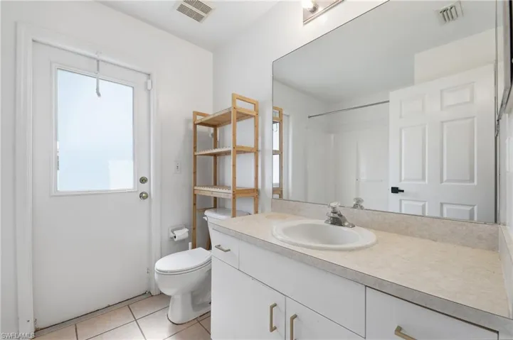 White vanity with an integrated sink and light-toned countertop